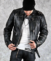 Person wearing a black leather jacket and white shirt with 'Wolves' text on a gray background