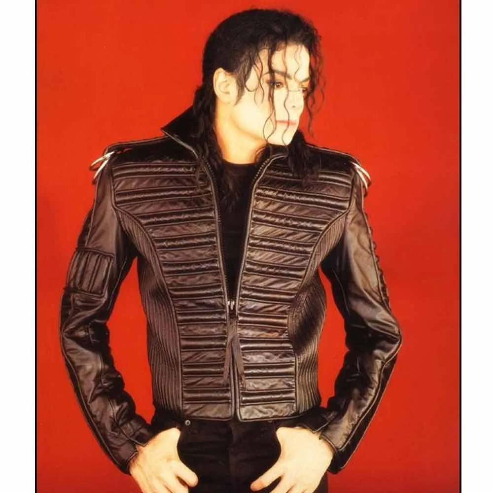 Person wearing a black quilted jacket against a background