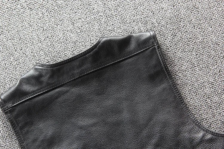 Black leather jacket on a textured gray surface