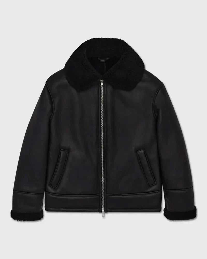 Black leather jacket with fur collar on a light gray background