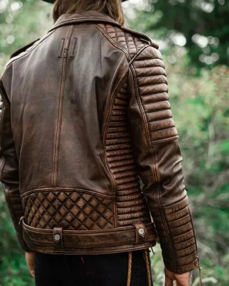Brown leather jacket with quilted design on a blurred green background