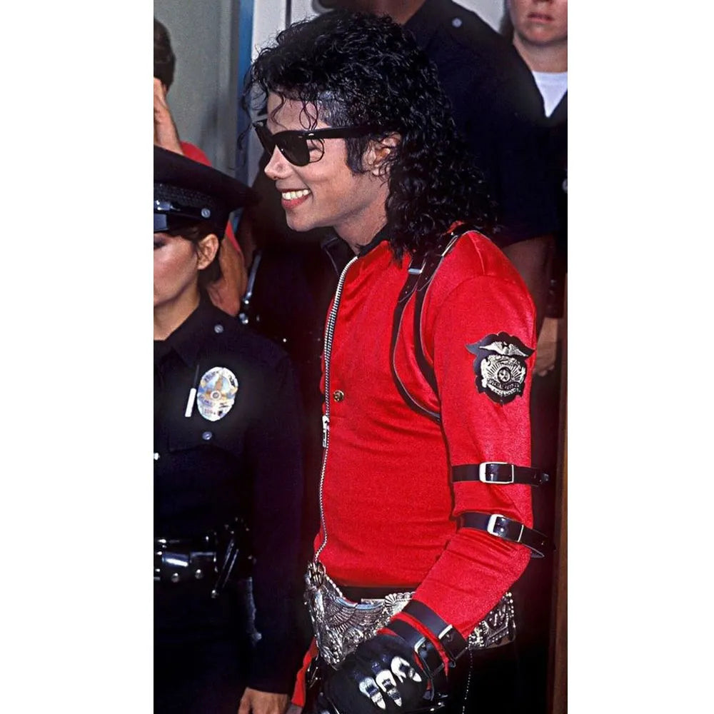 Person in a red outfit with black accents and sunglasses, standing next to a police officer.