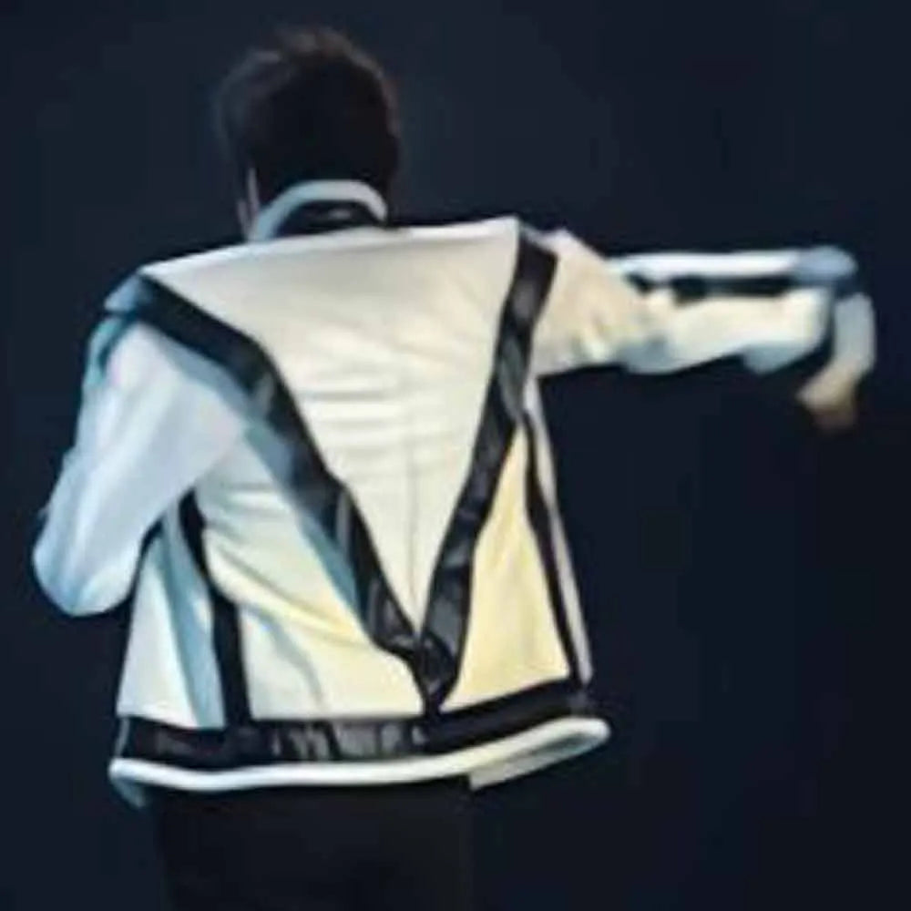 Person wearing a reflective safety vest with black and white design on a dark background