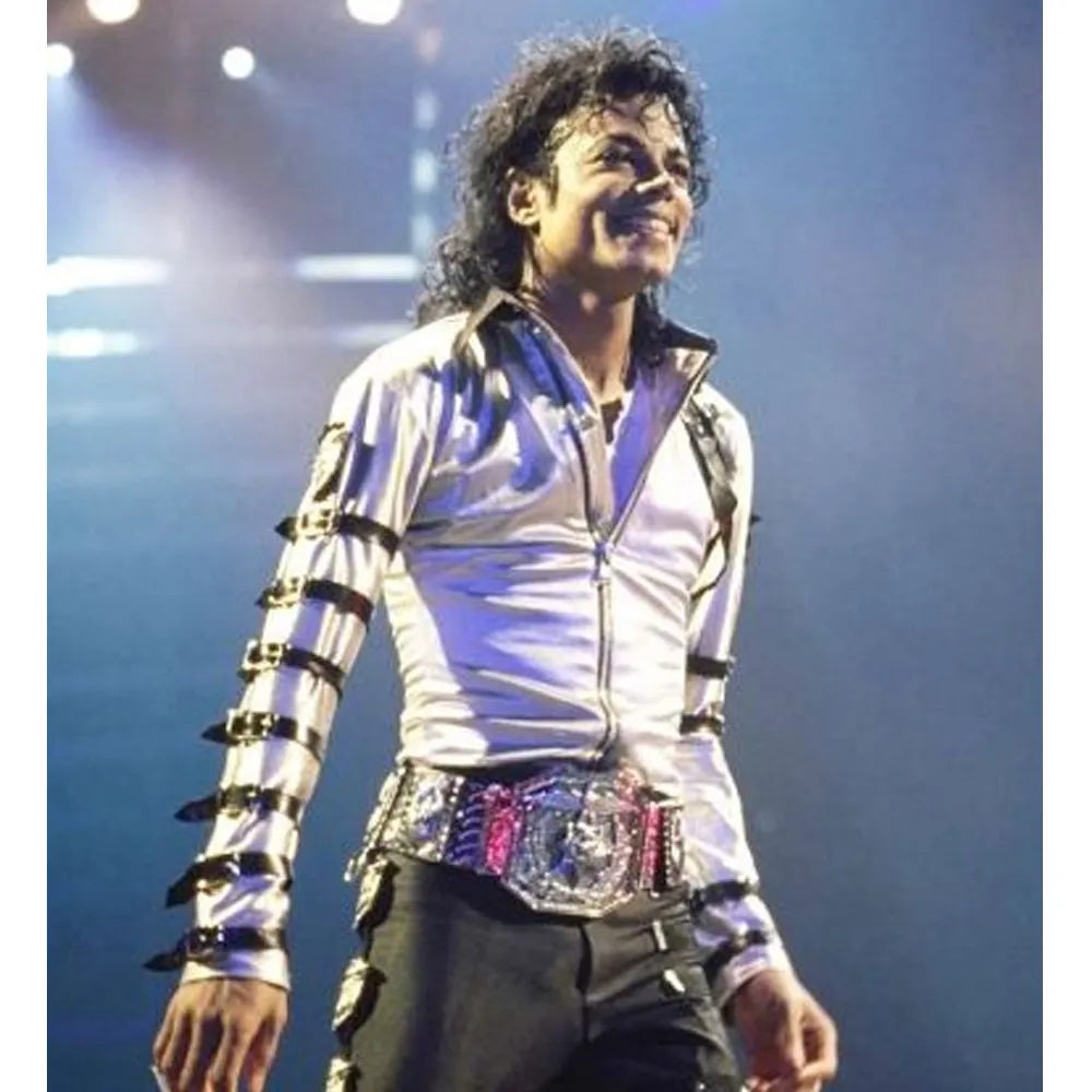 Person wearing a silver jacket with black accents on stage