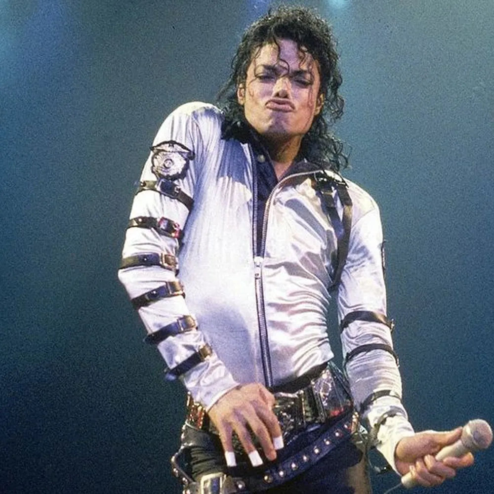 Person wearing a white jacket with black accents on a dark background