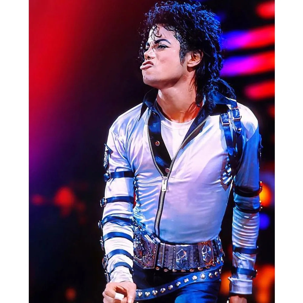 Person wearing a white outfit with blue accents on a stage with colorful lighting